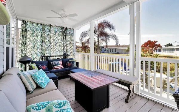 a bedroom with furniture wooden floor and a large window