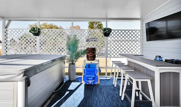 a kitchen with stainless steel appliances wooden floor dining table and chairs