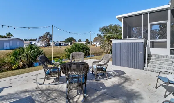 a view of a patio with table and chairs and potted plants