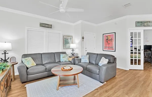 a living room with furniture and a wooden floor