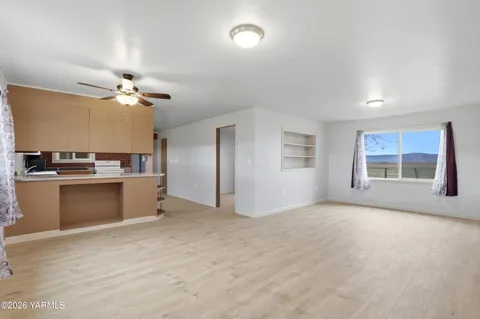 a view of kitchen with cabinets and window