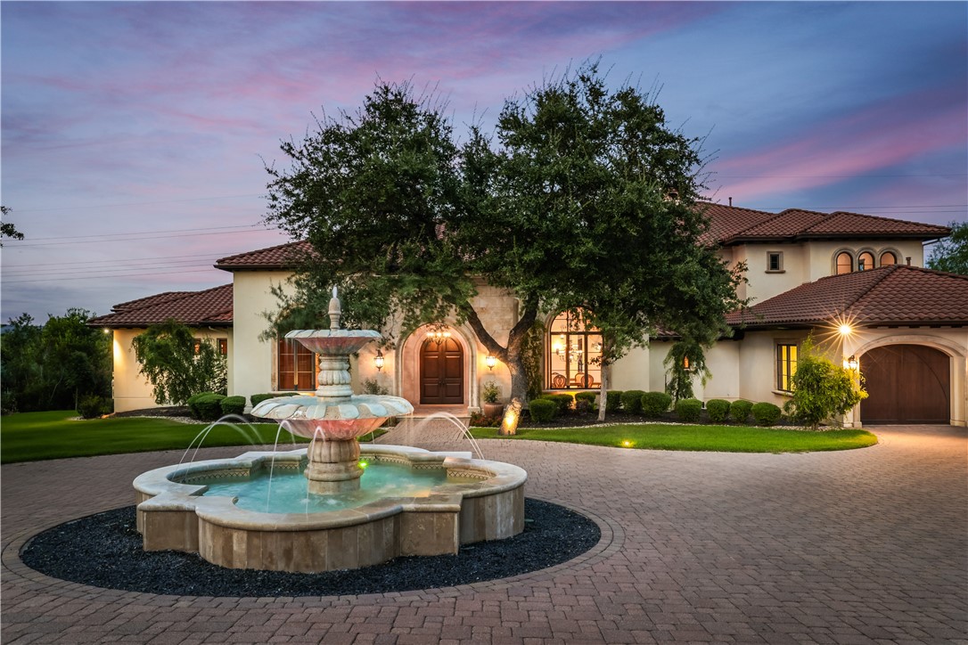 a patio with table and chairs and a fountain