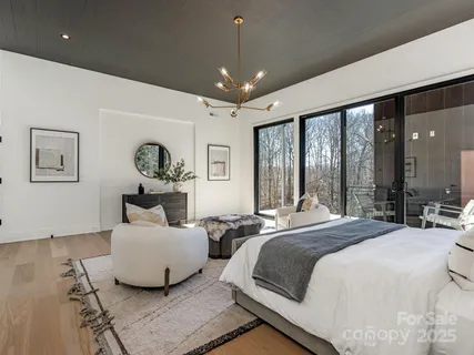 a spacious bedroom with a bed window and couch