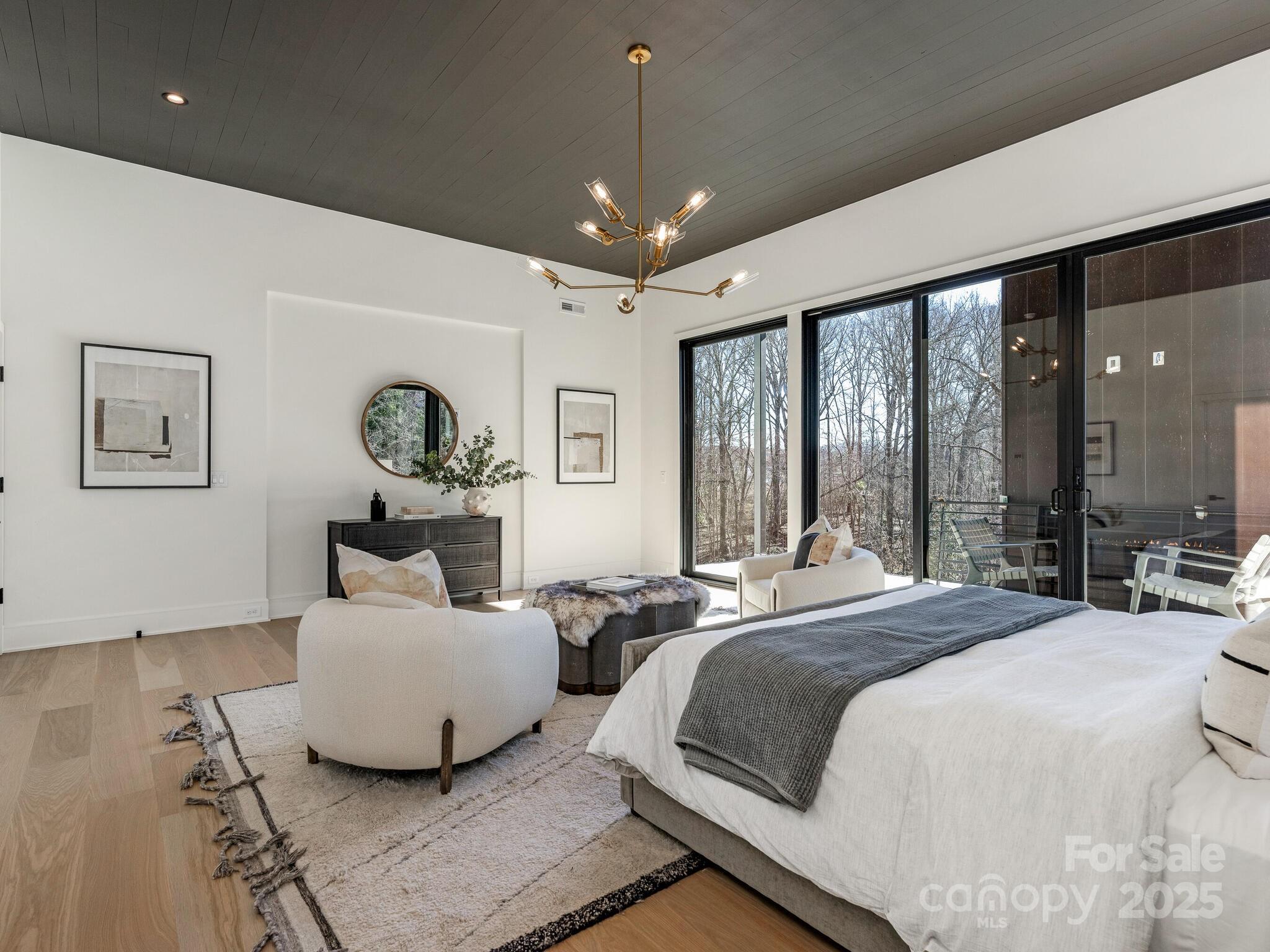 2832 Arcadia Avenue Charlotte, NC 28209 - Photo 22 of 48 a spacious bedroom with a bed window and couch