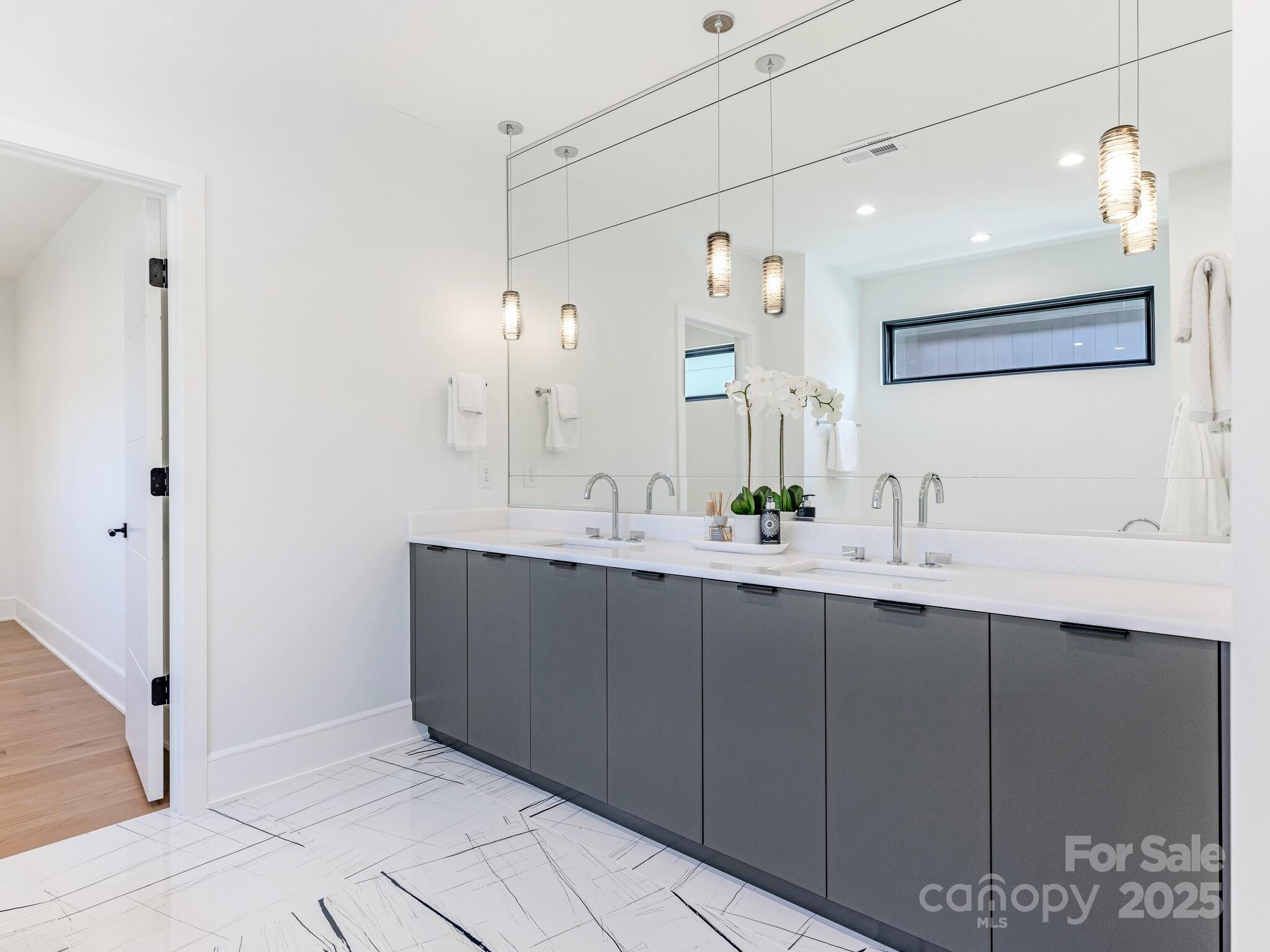 2832 Arcadia Avenue Charlotte, NC 28209 - Photo 24 of 48 a bathroom with a sink and a mirror