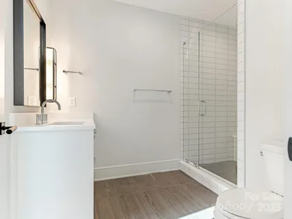 a bathroom with a shower and a sink