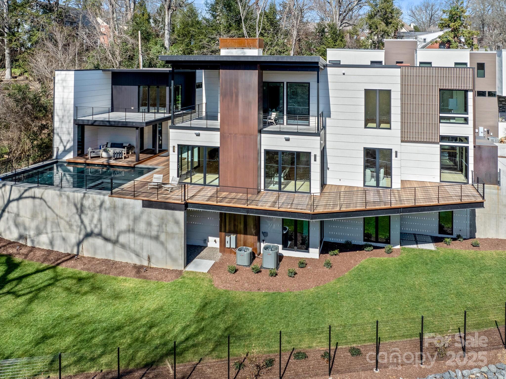 2832 Arcadia Avenue Charlotte, NC 28209 - Photo 4 of 48 a view of a patio with table and chairs with wooden fence