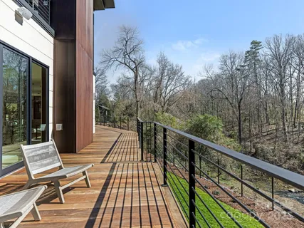 a view of balcony with wooden floor and bench