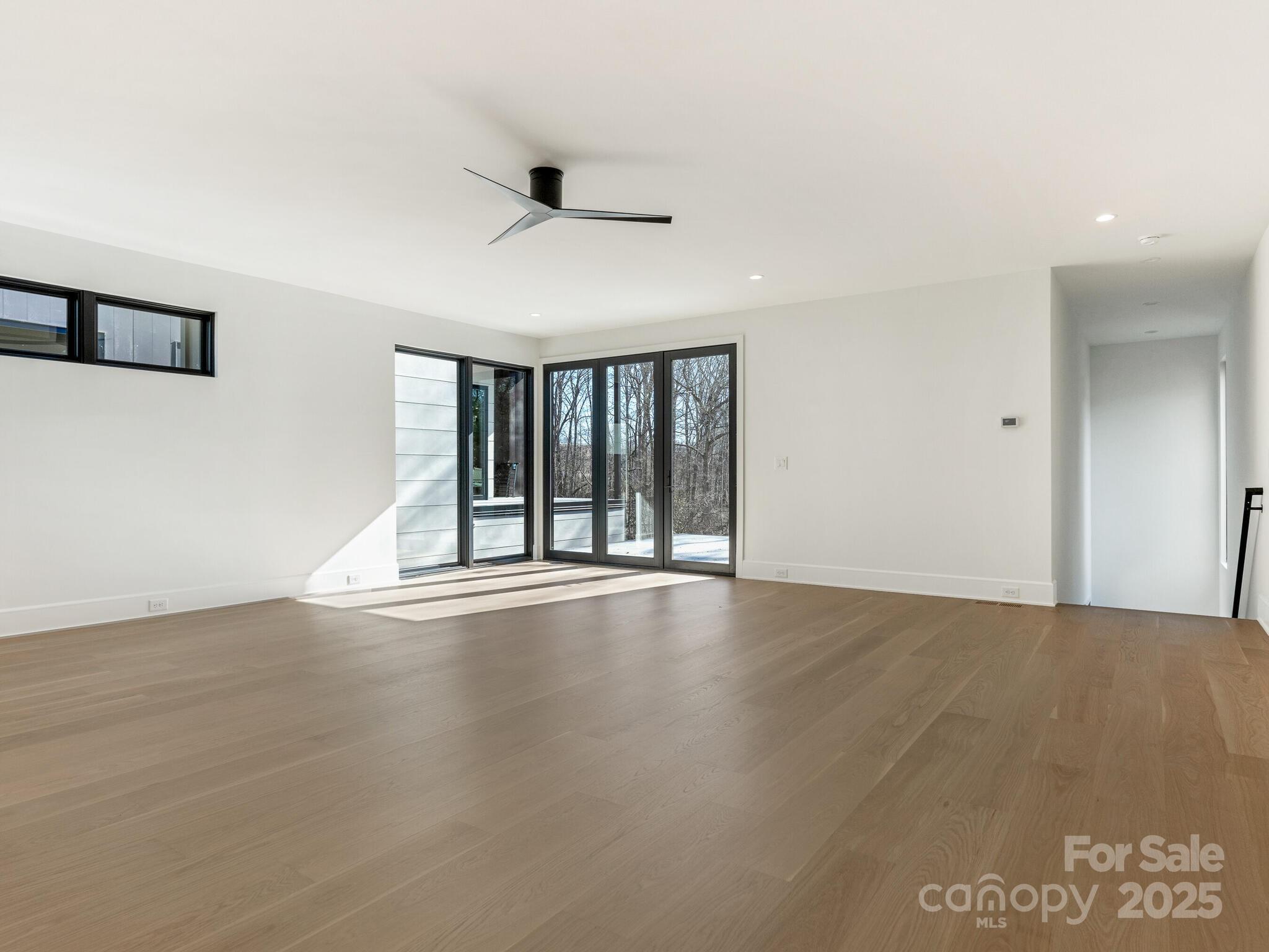 2832 Arcadia Avenue Charlotte, NC 28209 - Photo 44 of 48 a view of an empty room with wooden floor and a window