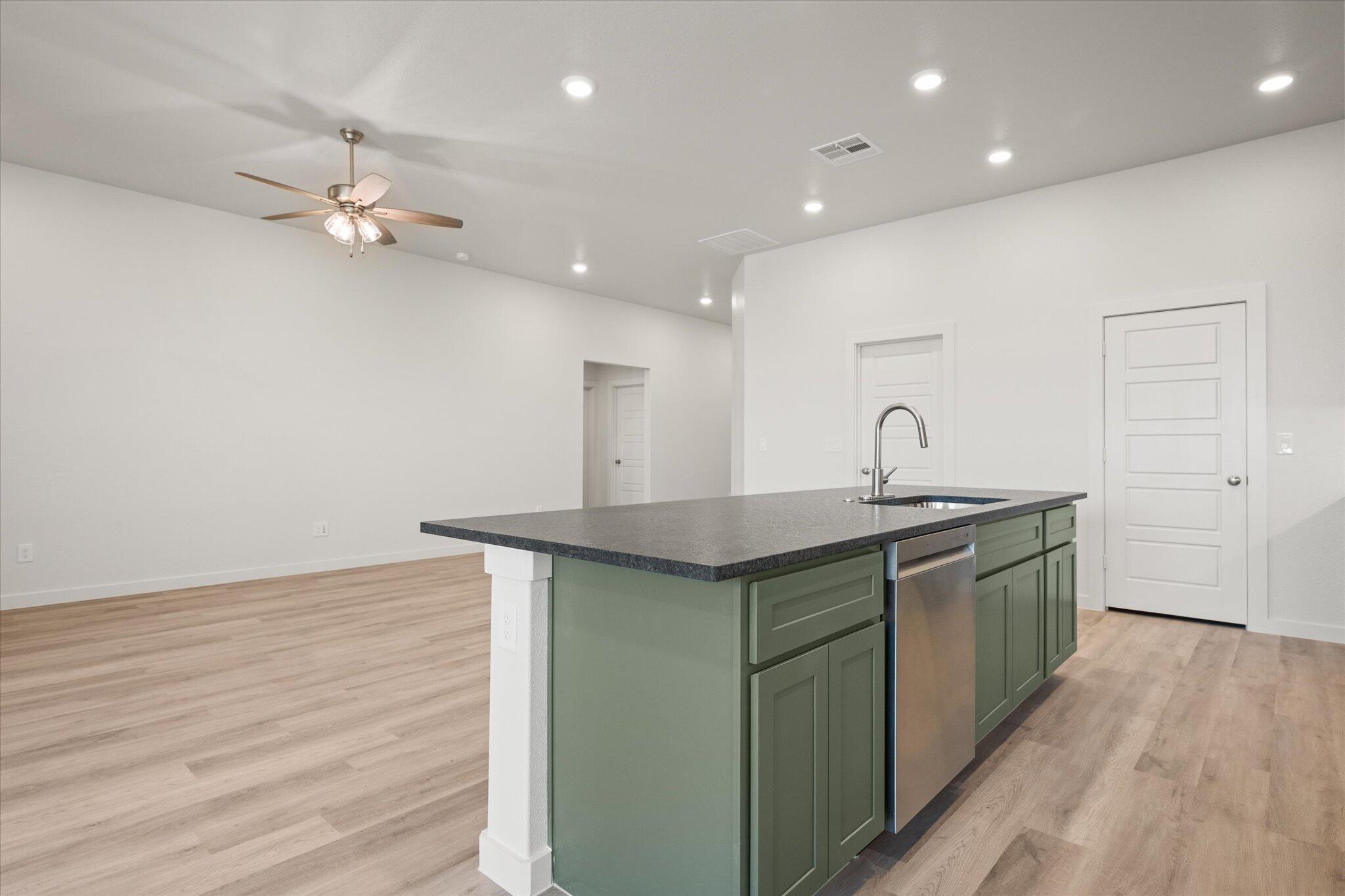 6105 121st Street Lubbock, TX 79424 - Photo 13 of 24 a kitchen with a sink and stove