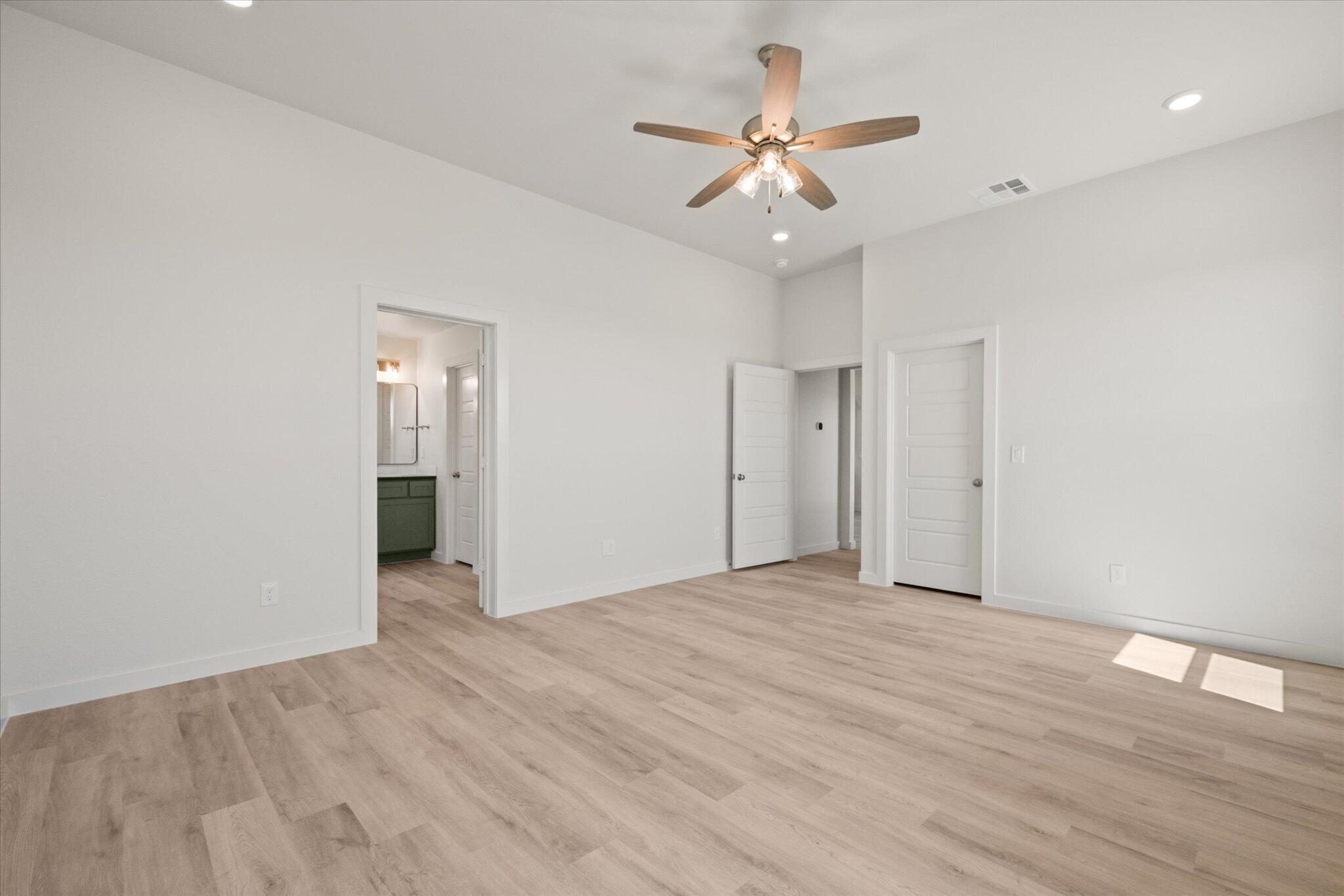 6105 121st Street Lubbock, TX 79424 - Photo 15 of 24 a view of an empty room with wooden floor