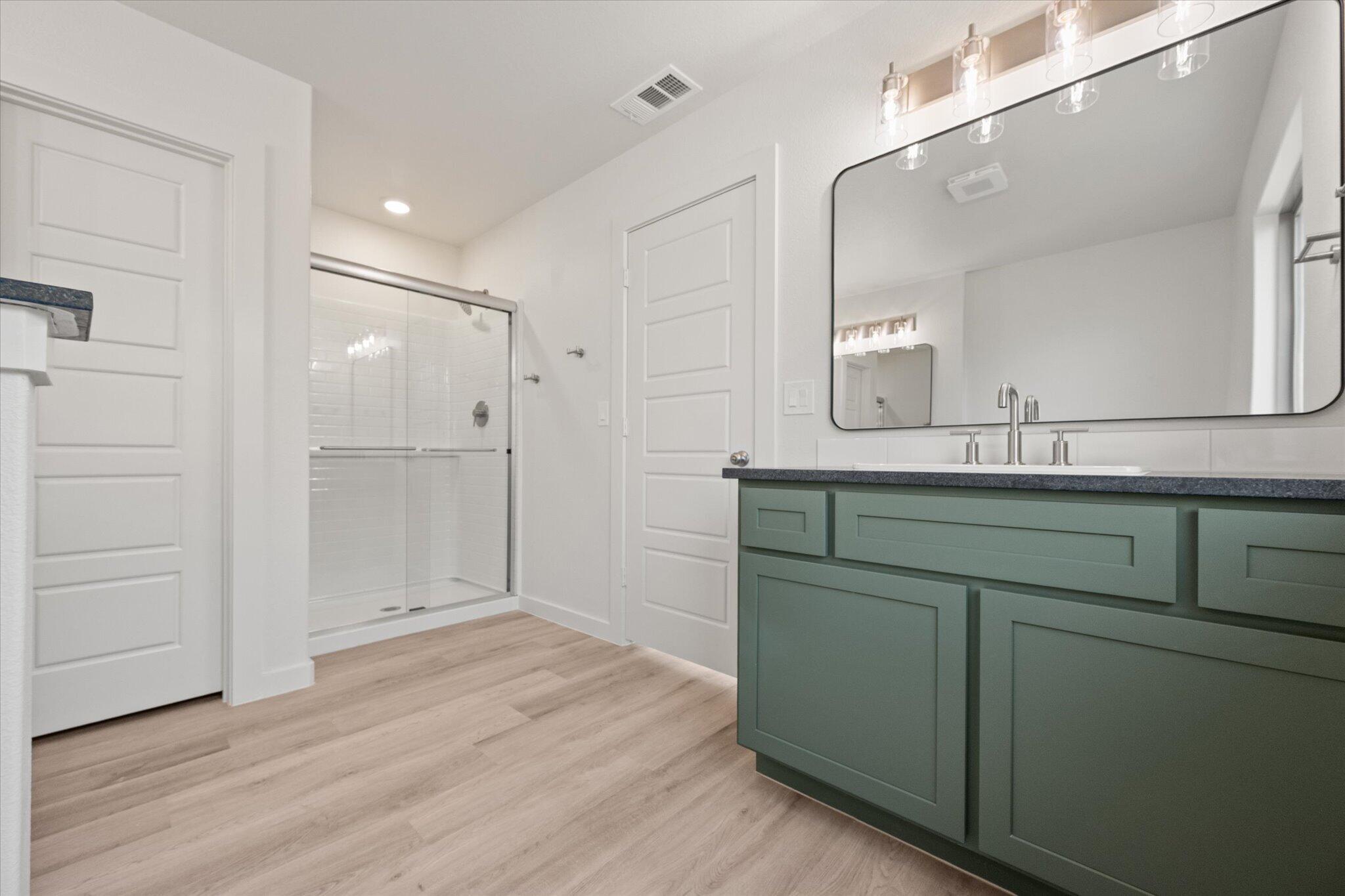 6105 121st Street Lubbock, TX 79424 - Photo 17 of 24 a bathroom with a sink and a mirror
