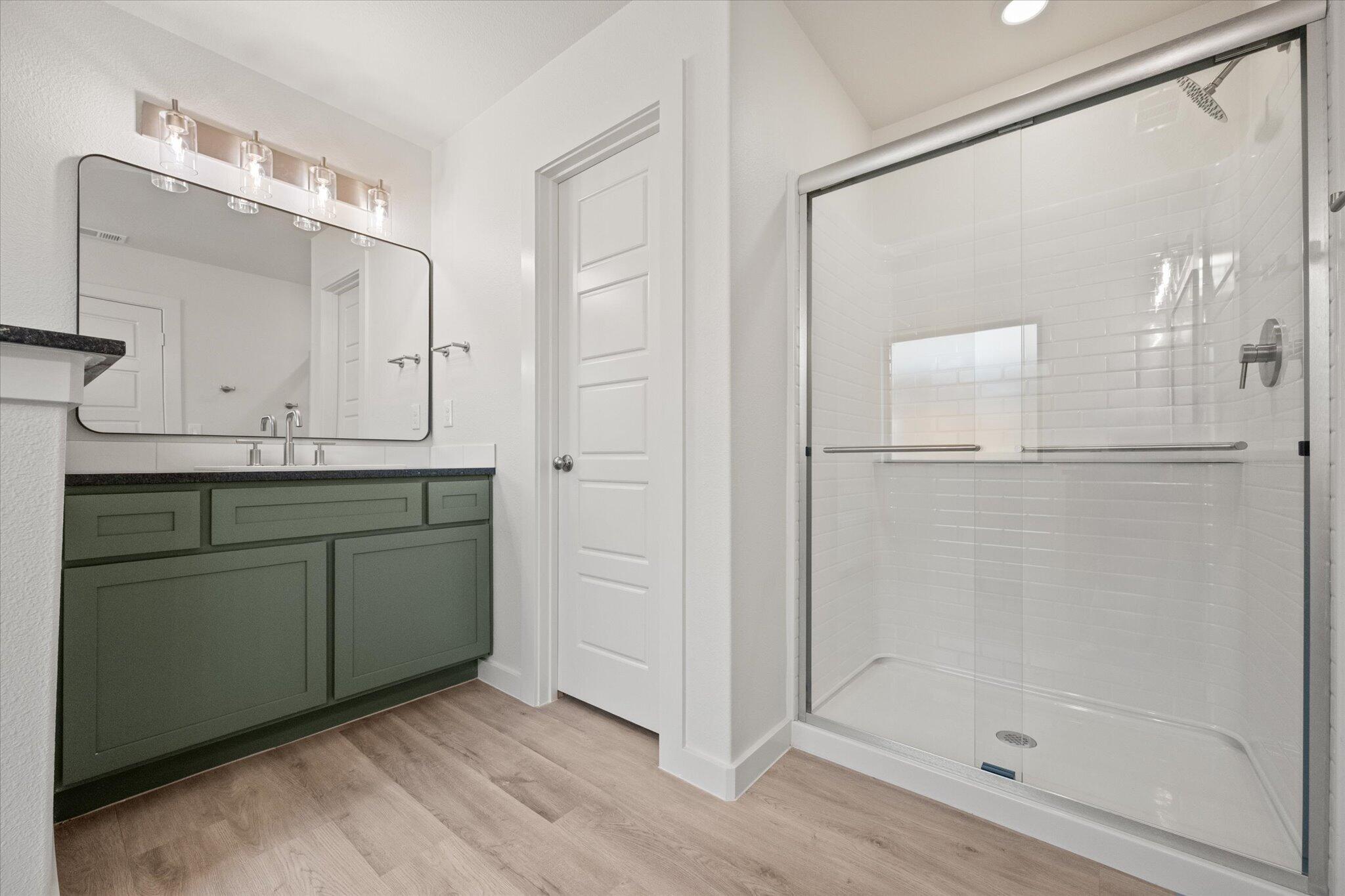 6105 121st Street Lubbock, TX 79424 - Photo 18 of 24 a bathroom with a shower sink and mirror