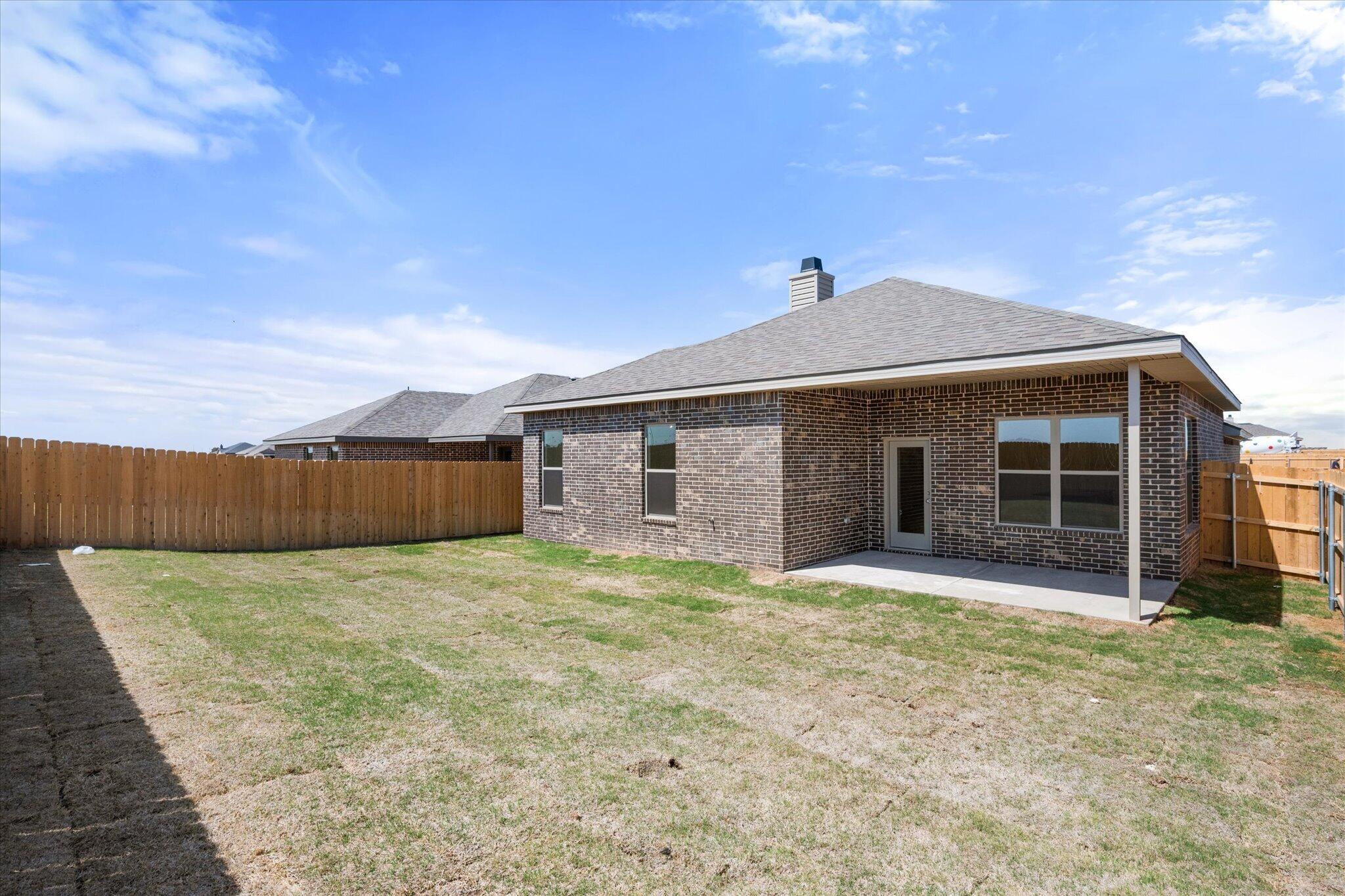 6105 121st Street Lubbock, TX 79424 - Photo 24 of 24 a front view of house with yard and trees in the background