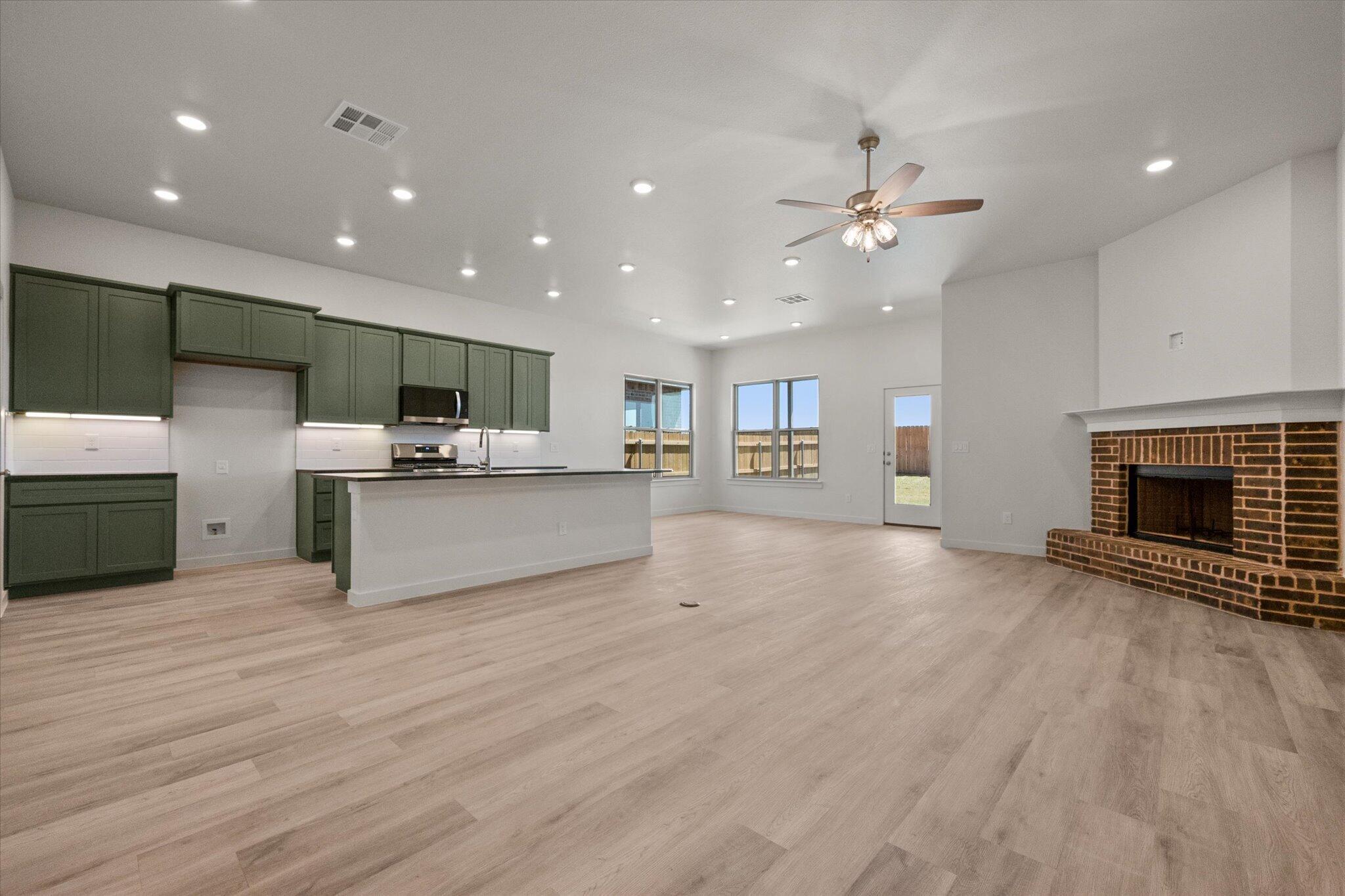 6105 121st Street Lubbock, TX 79424 - Photo 6 of 24 a view of kitchen with cabinets and wooden floor