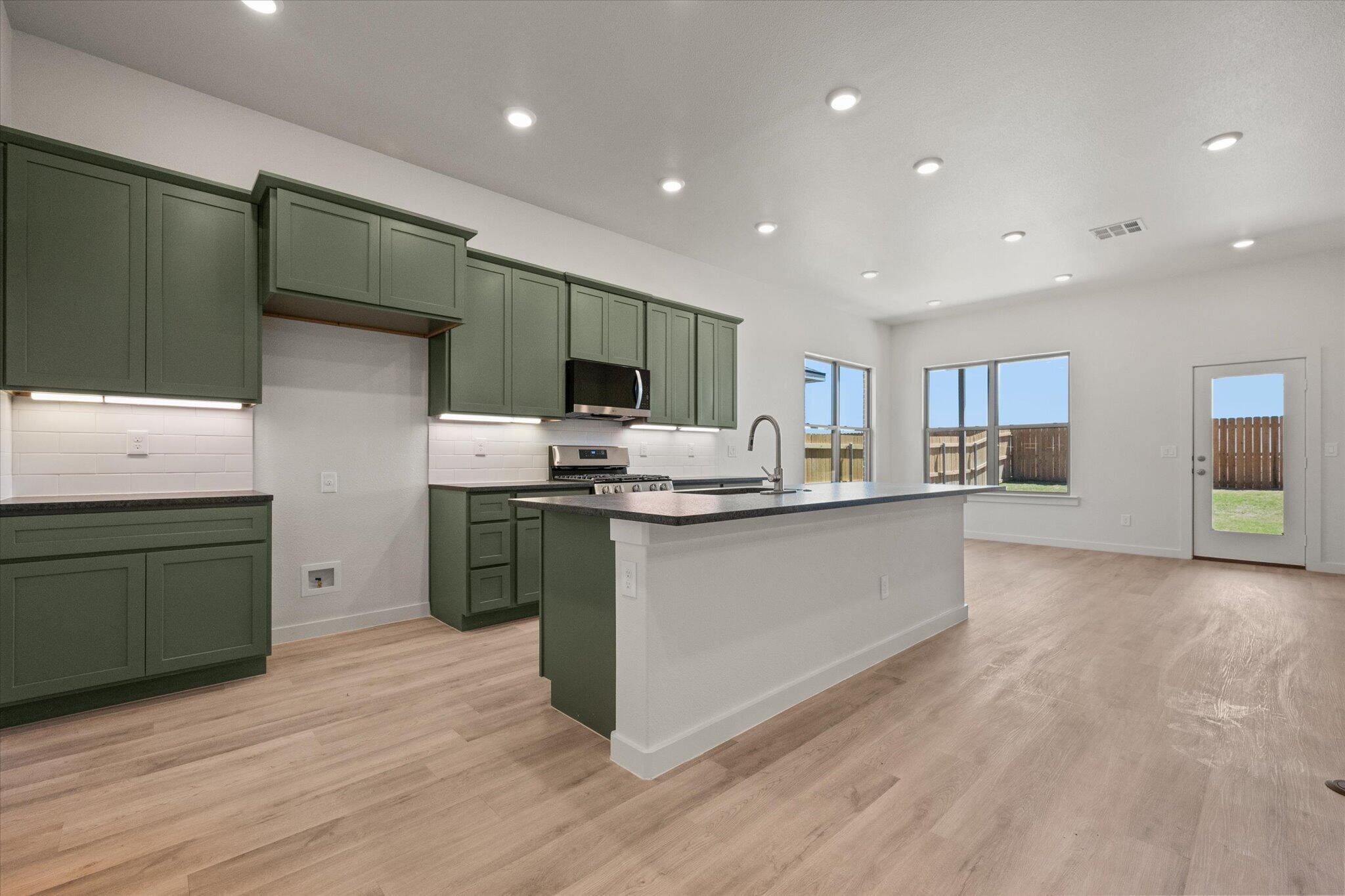 6105 121st Street Lubbock, TX 79424 - Photo 7 of 24 a kitchen with stainless steel appliances granite countertop a refrigerator stove and oven