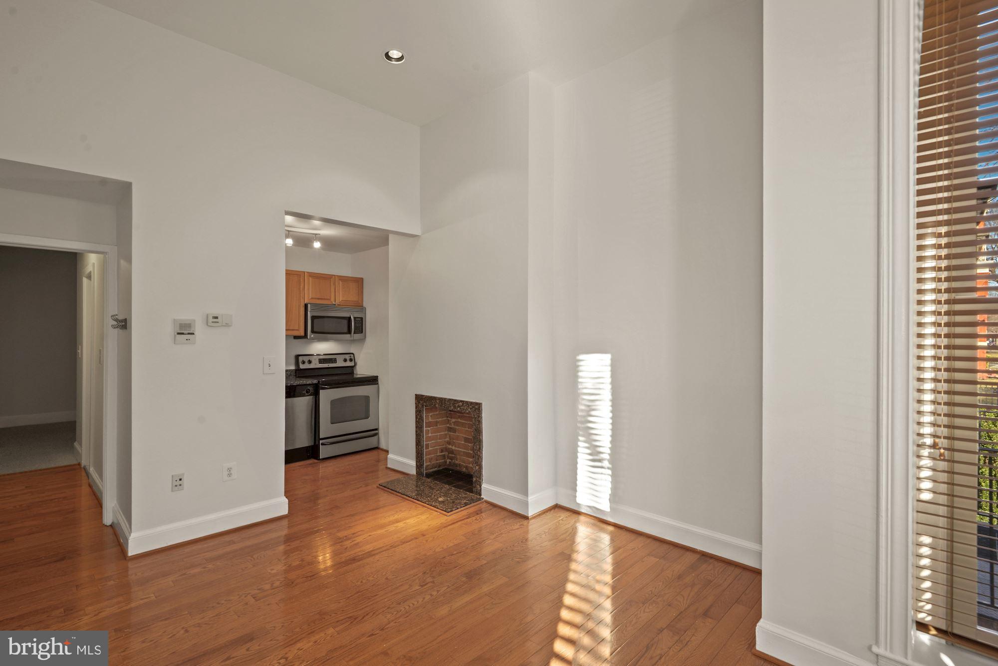 1305 P Street Northwest, Unit 1 Washington, DC 20005 - Photo 8 of 22 Faux fireplace adds some interest to your room.