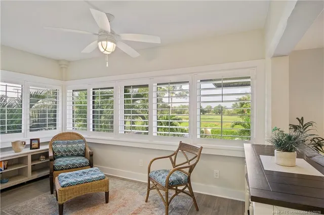 a living room with furniture and floor to ceiling windows