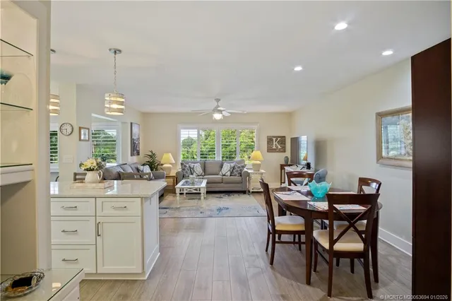 a view of a dining room and livingroom with furniture window and wooden floor