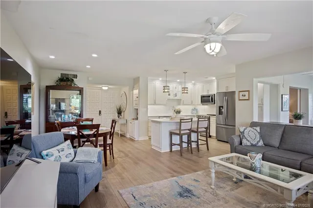 a living room with furniture kitchen view and a dining table