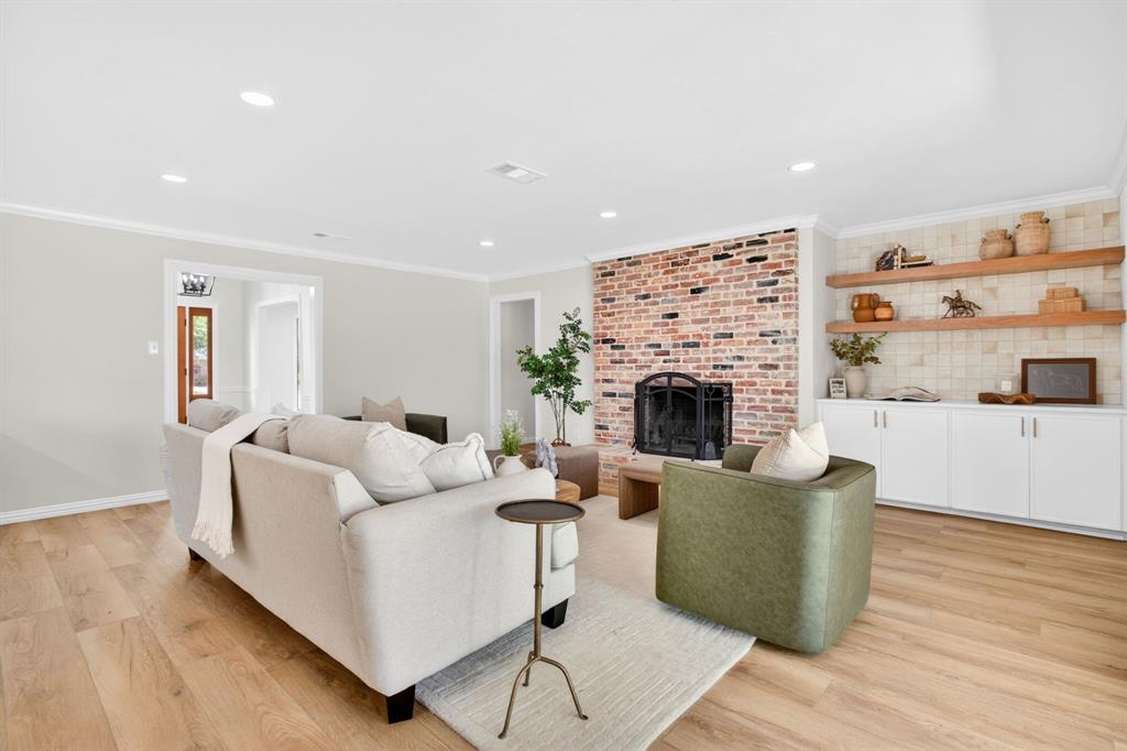 4316 Winding Way Benbrook, TX 76126 - Photo 11 of 40 a living room with furniture a fireplace and a flat screen tv