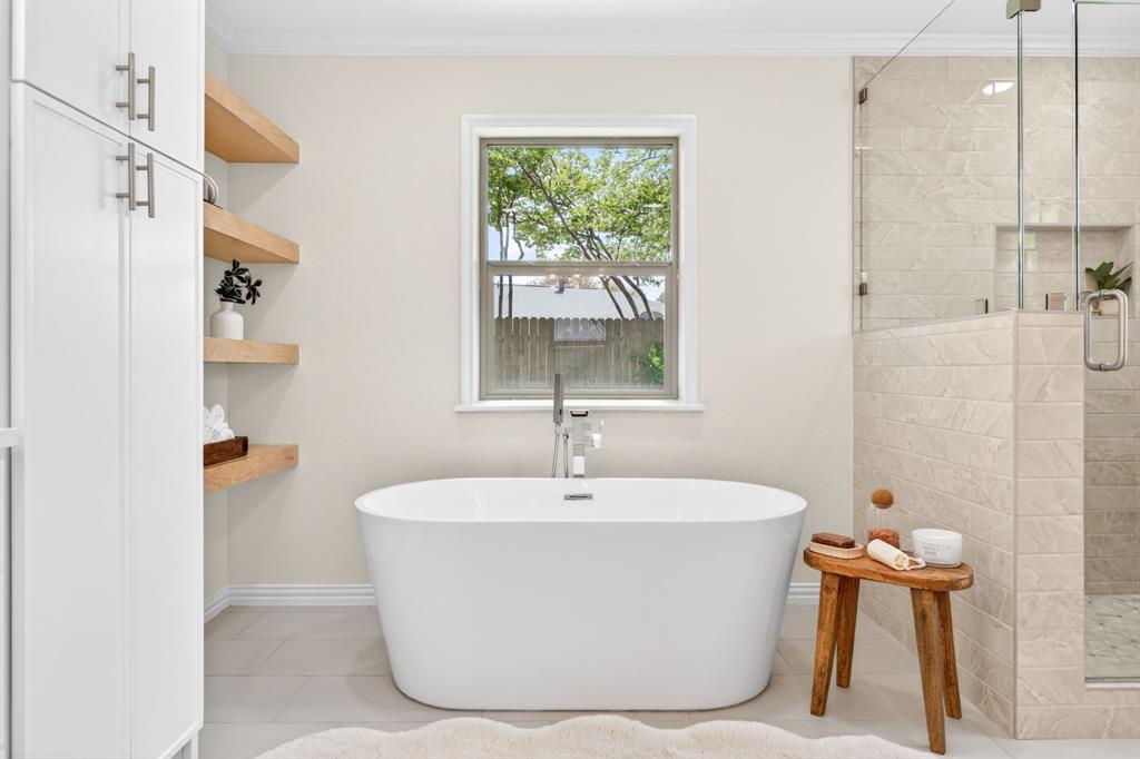 4316 Winding Way Benbrook, TX 76126 - Photo 23 of 40 a white bath tub sitting in a bathroom next to a window