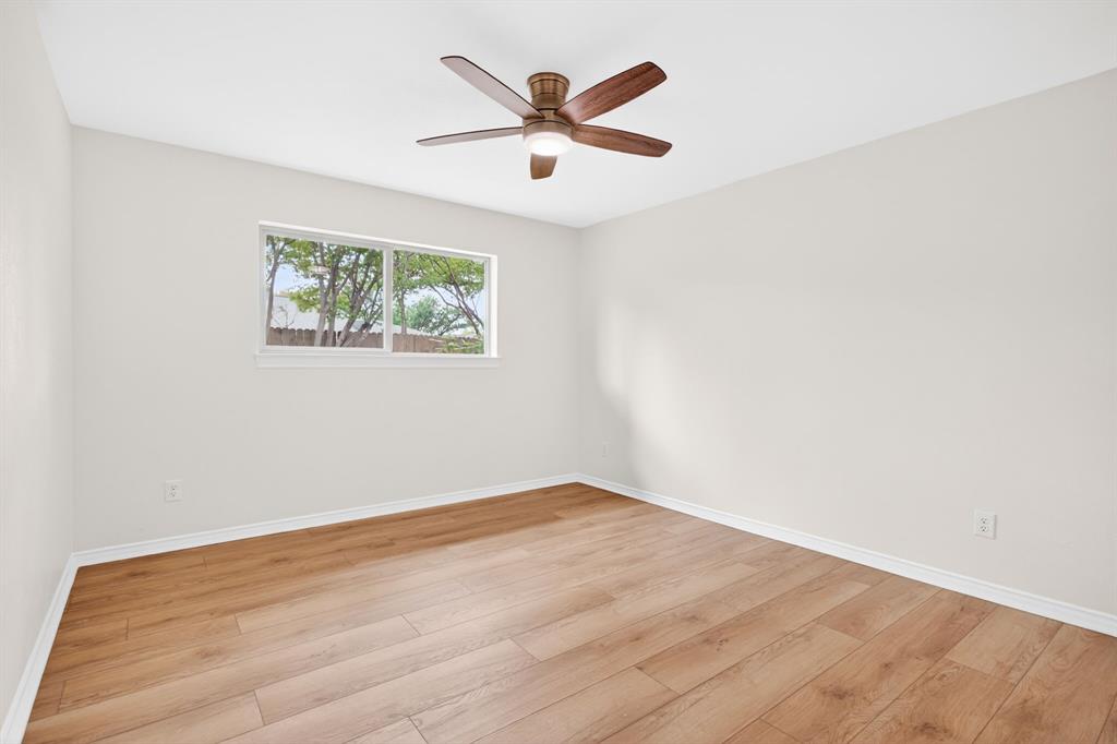 4316 Winding Way Benbrook, TX 76126 - Photo 25 of 40 an empty room with wooden floor and ceiling fan