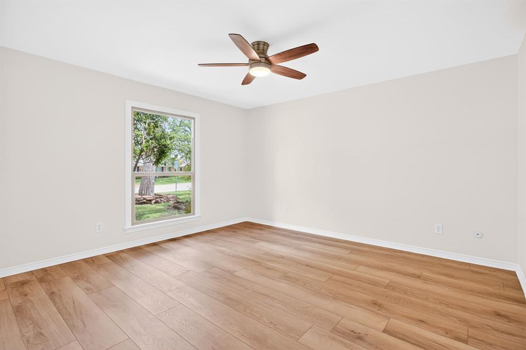 4316 Winding Way Benbrook, TX 76126 - Photo 29 of 40 an empty room with wooden floor and windows