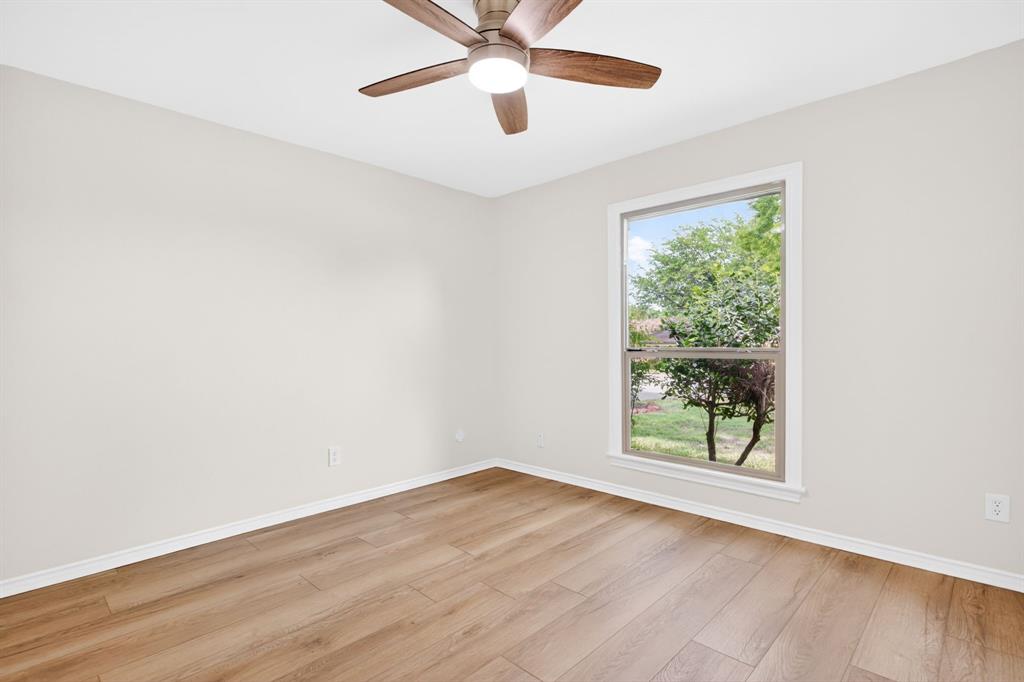 4316 Winding Way Benbrook, TX 76126 - Photo 32 of 40 an empty room with wooden floor chandelier fan and windows
