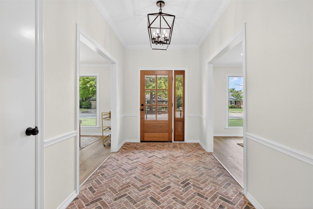 4316 Winding Way Benbrook, TX 76126 - Photo 4 of 40 a view of a hallway with windows and chandelier
