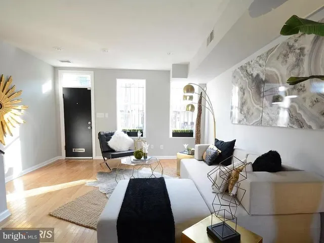 a living room with furniture and a rug