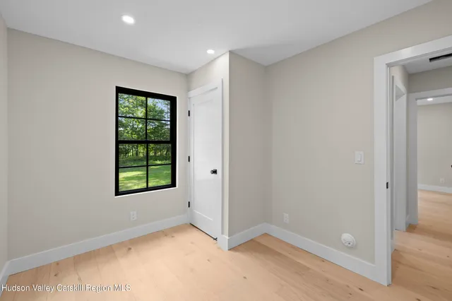 an empty room with windows and closet