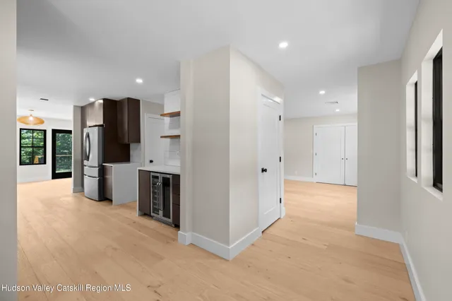 a view of a kitchen with a refrigerator and a sink