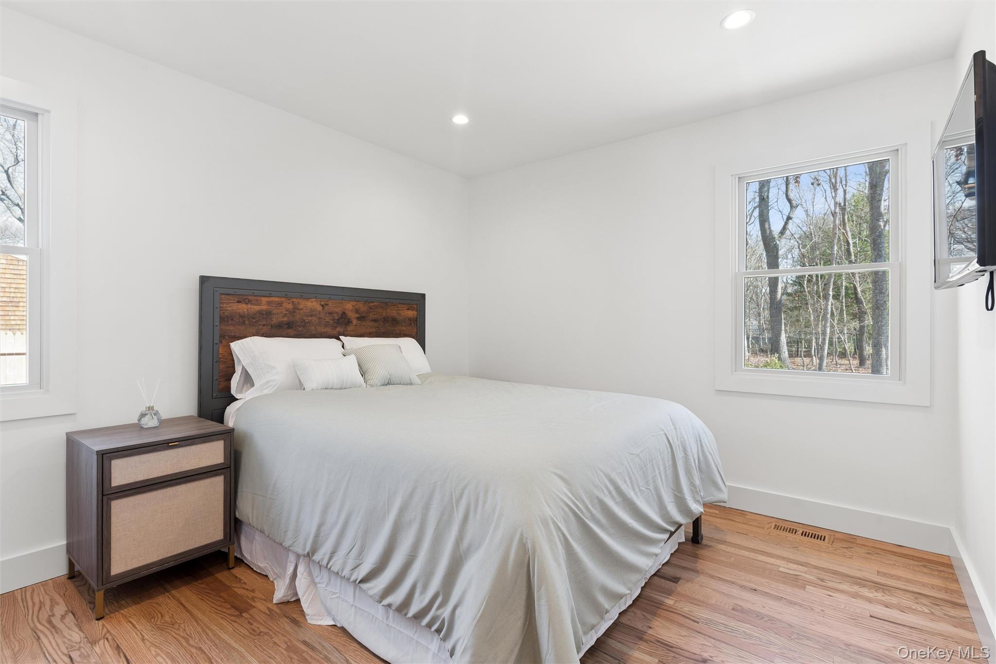 502 Springs Fireplace Road East Hampton, NY 11937 - Photo 11 of 25 a bedroom with a bed and wooden floor