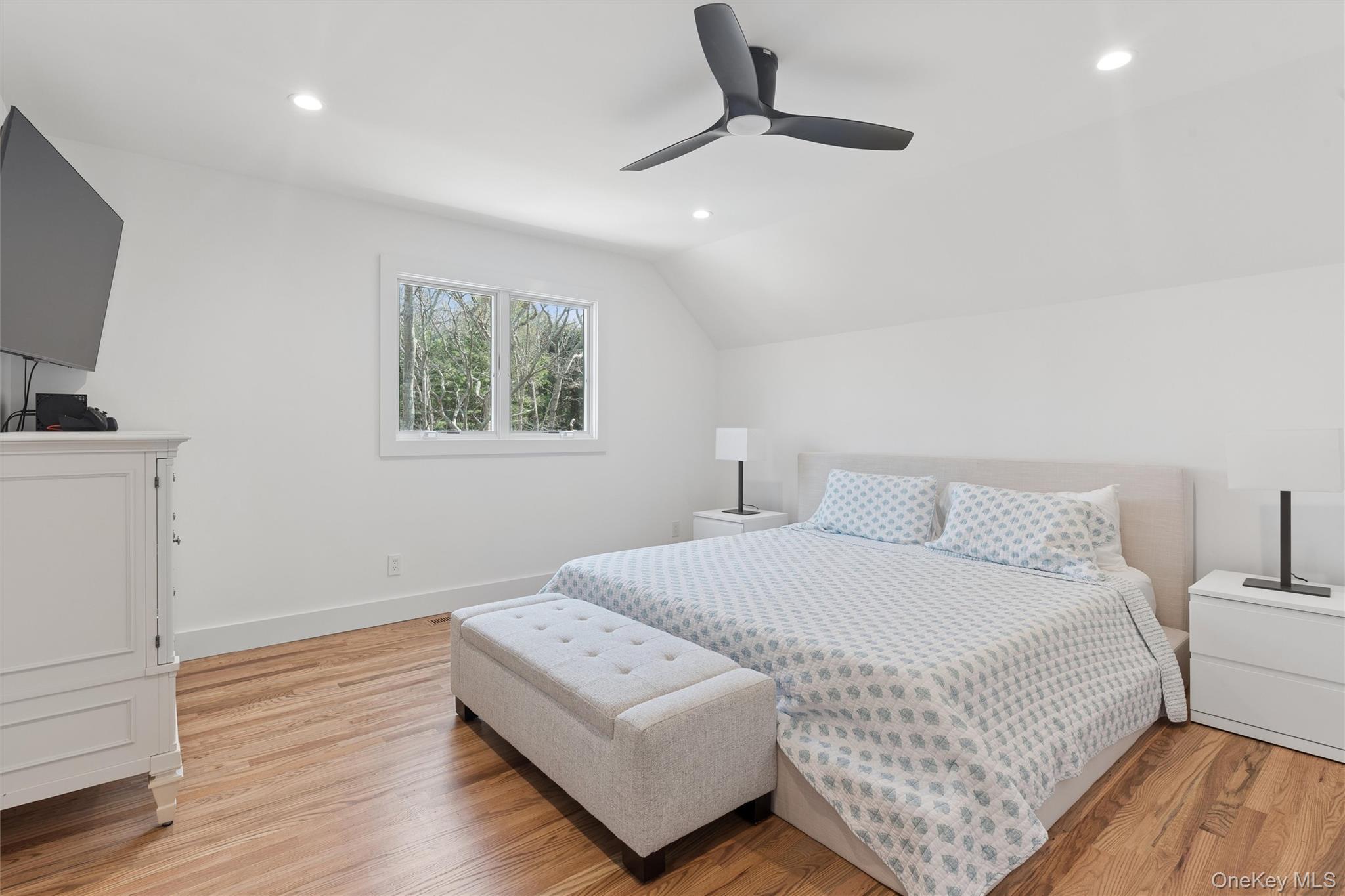 502 Springs Fireplace Road East Hampton, NY 11937 - Photo 14 of 25 a bedroom with a bed and a flat screen tv