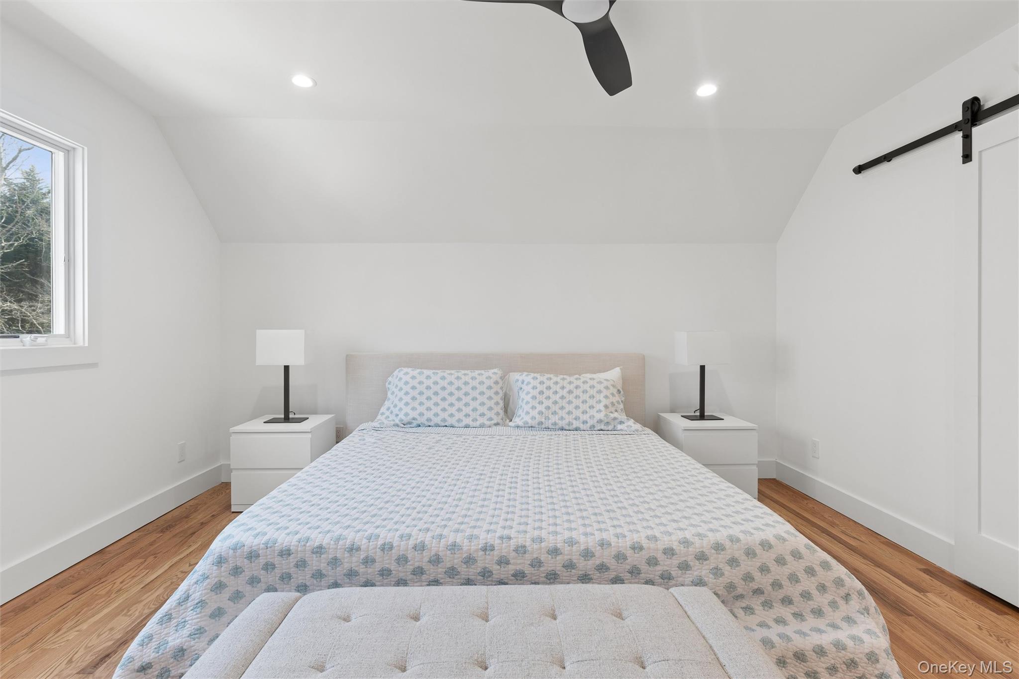 502 Springs Fireplace Road East Hampton, NY 11937 - Photo 15 of 25 a bedroom with a bed and a night stand