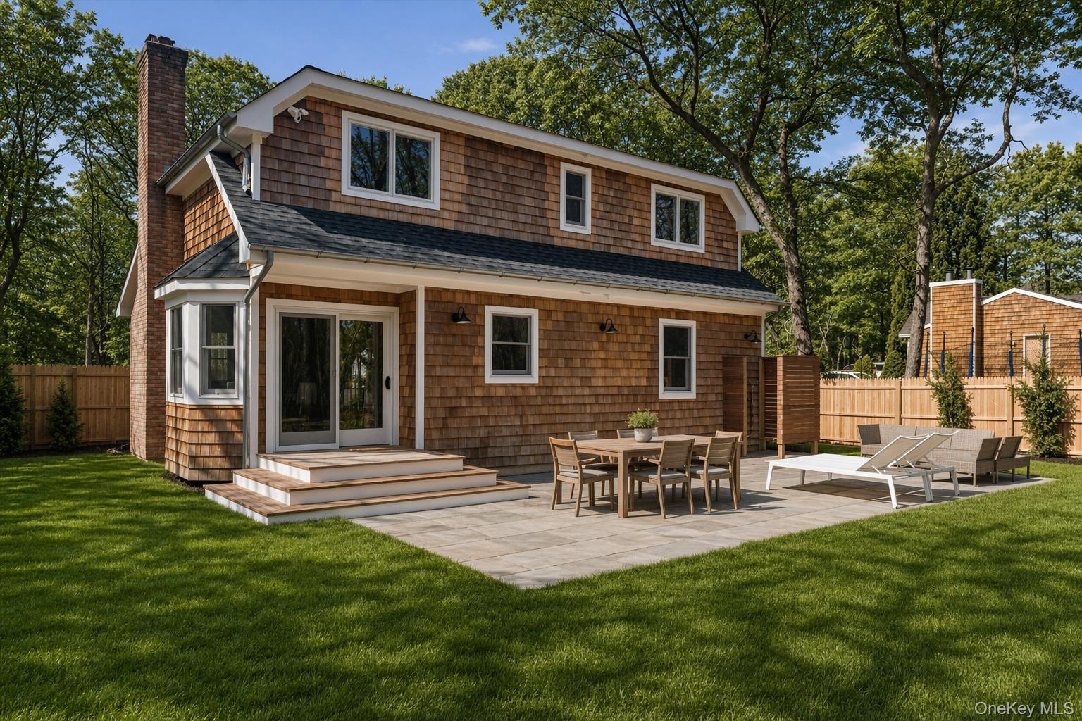 502 Springs Fireplace Road East Hampton, NY 11937 - Photo 2 of 25 a backyard of a house with table and chairs