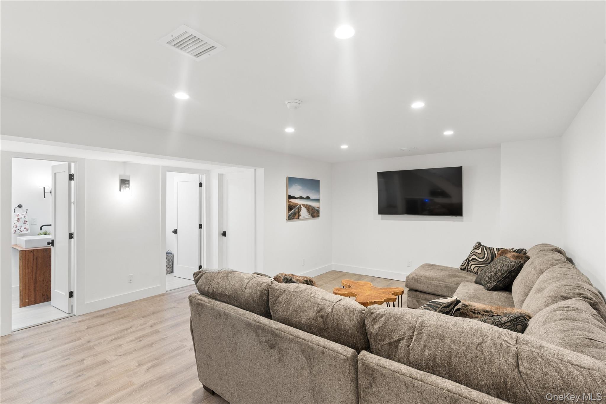 502 Springs Fireplace Road East Hampton, NY 11937 - Photo 22 of 25 a living room with furniture and a flat screen tv