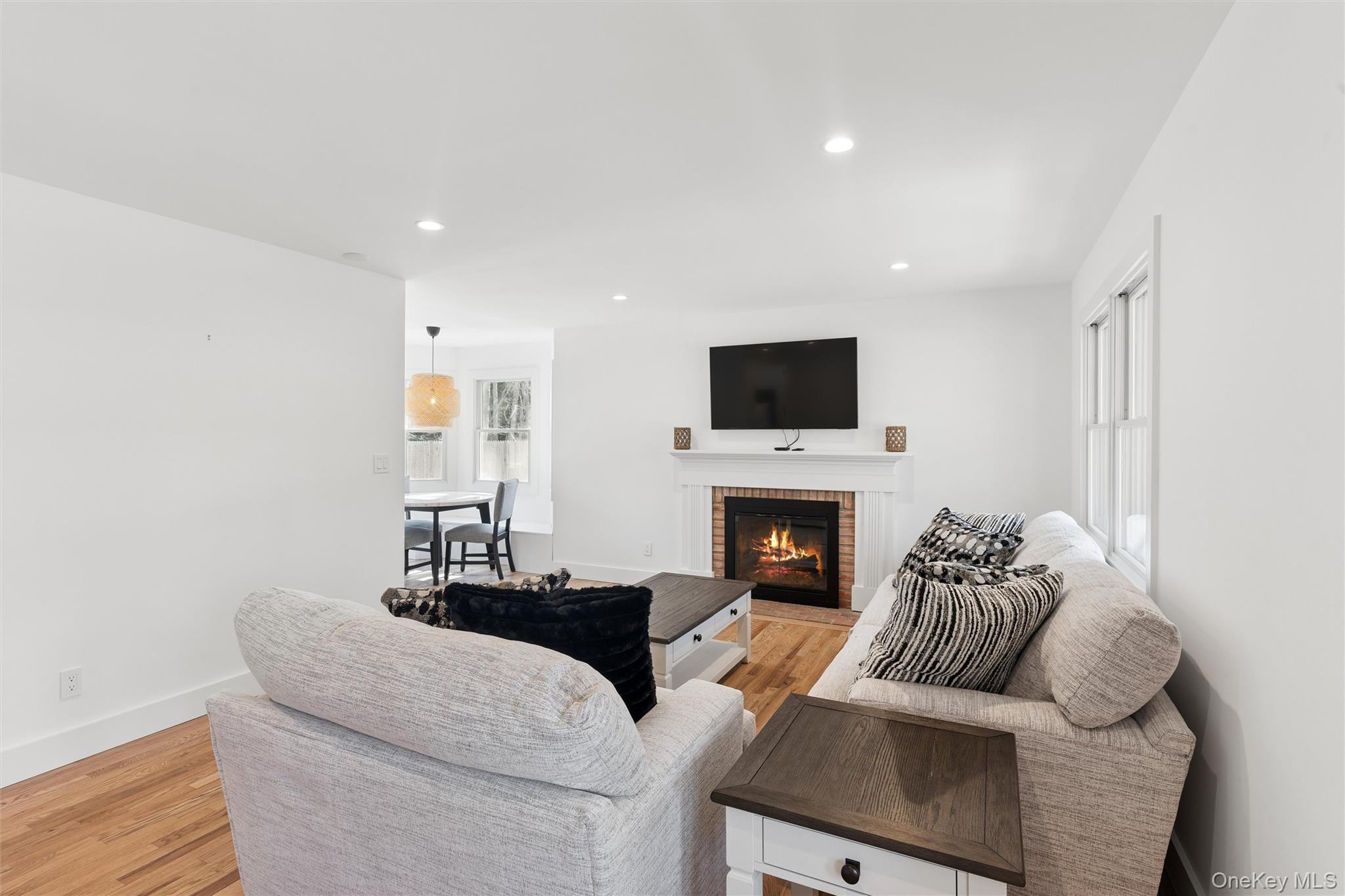 502 Springs Fireplace Road East Hampton, NY 11937 - Photo 4 of 25 a living room with furniture a fireplace and a flat screen tv