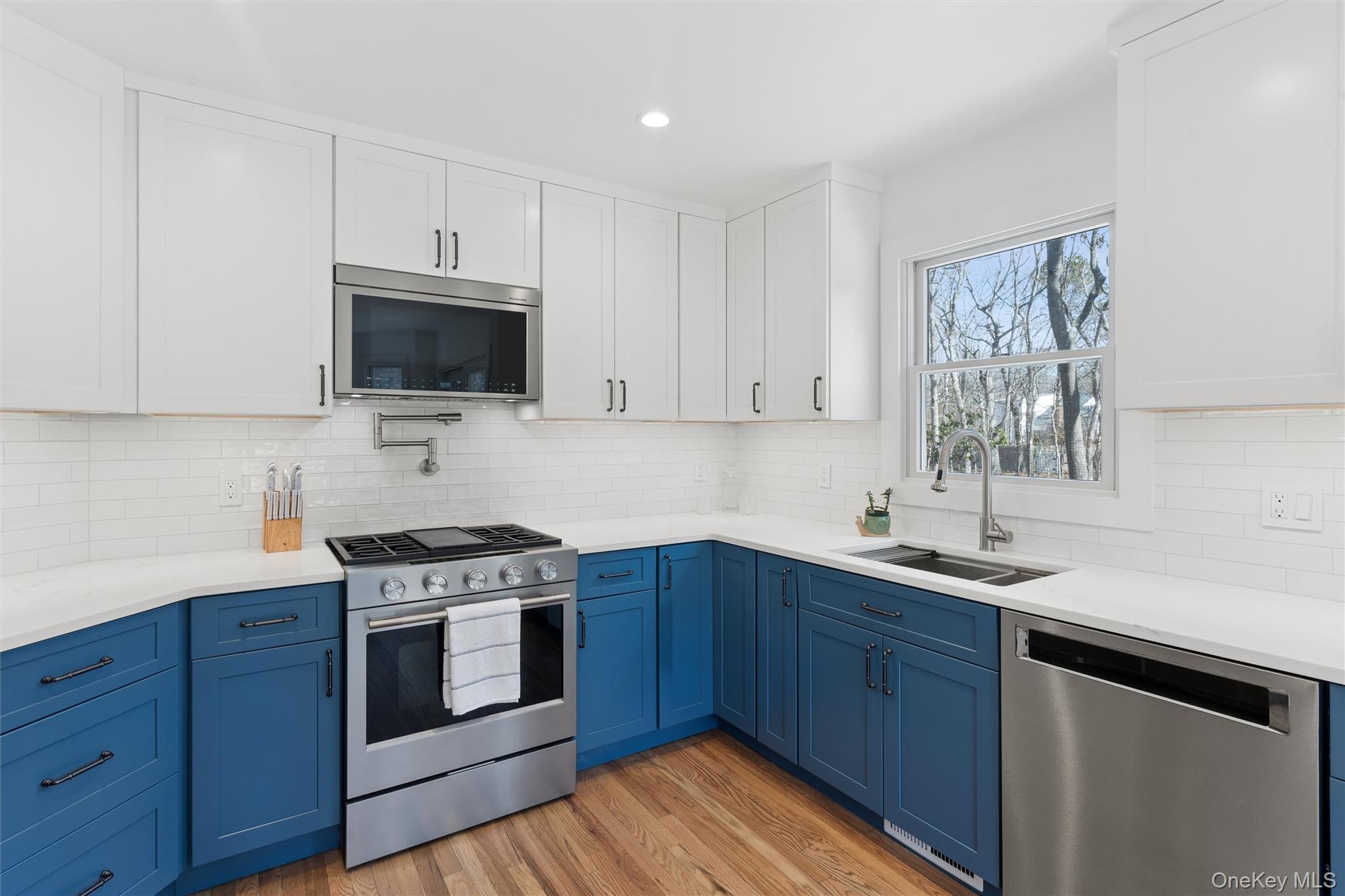 502 Springs Fireplace Road East Hampton, NY 11937 - Photo 7 of 25 a kitchen with stainless steel appliances a sink a stove and microwave