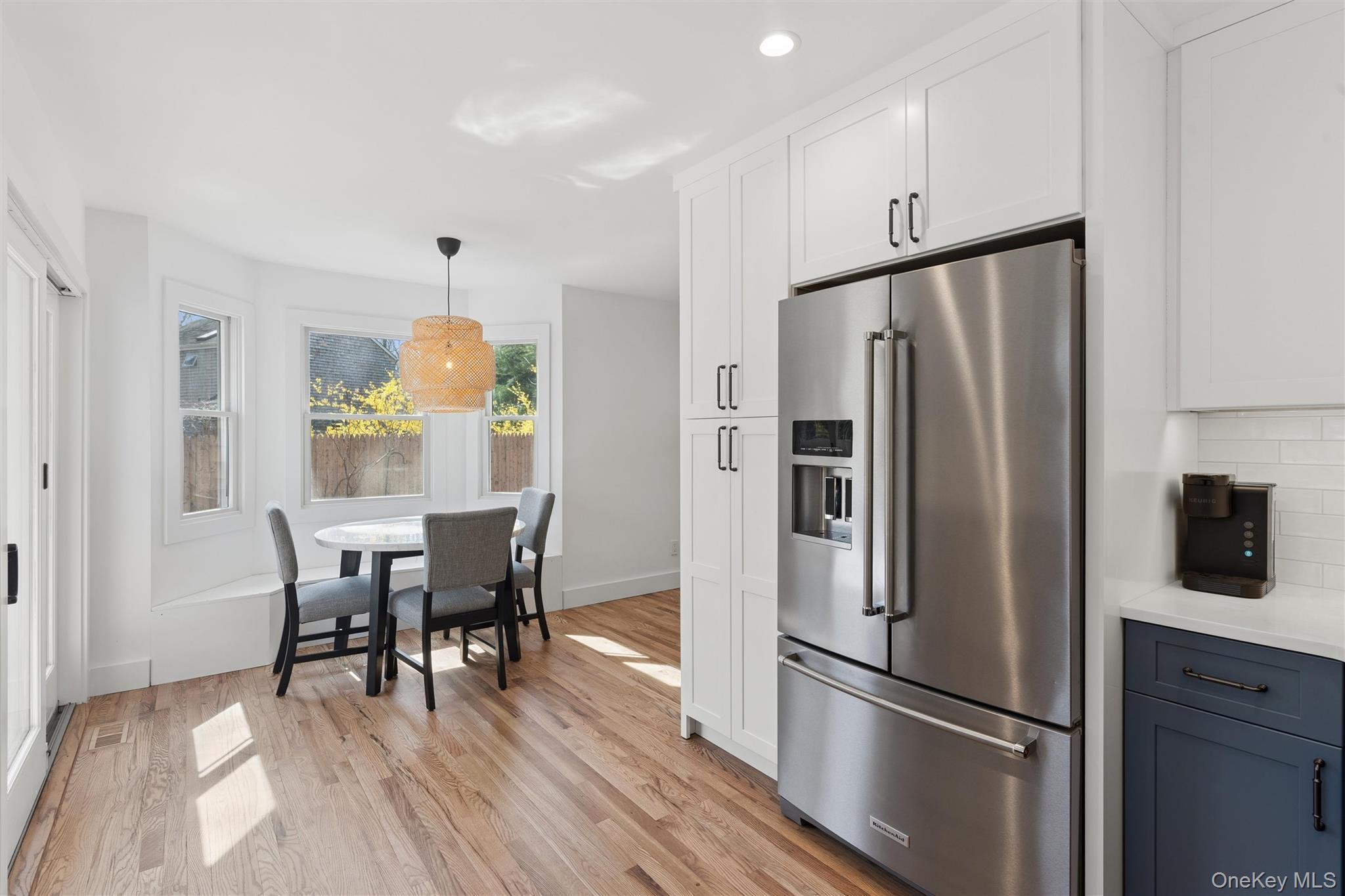 502 Springs Fireplace Road East Hampton, NY 11937 - Photo 9 of 25 a kitchen with a refrigerator a dining table and chairs