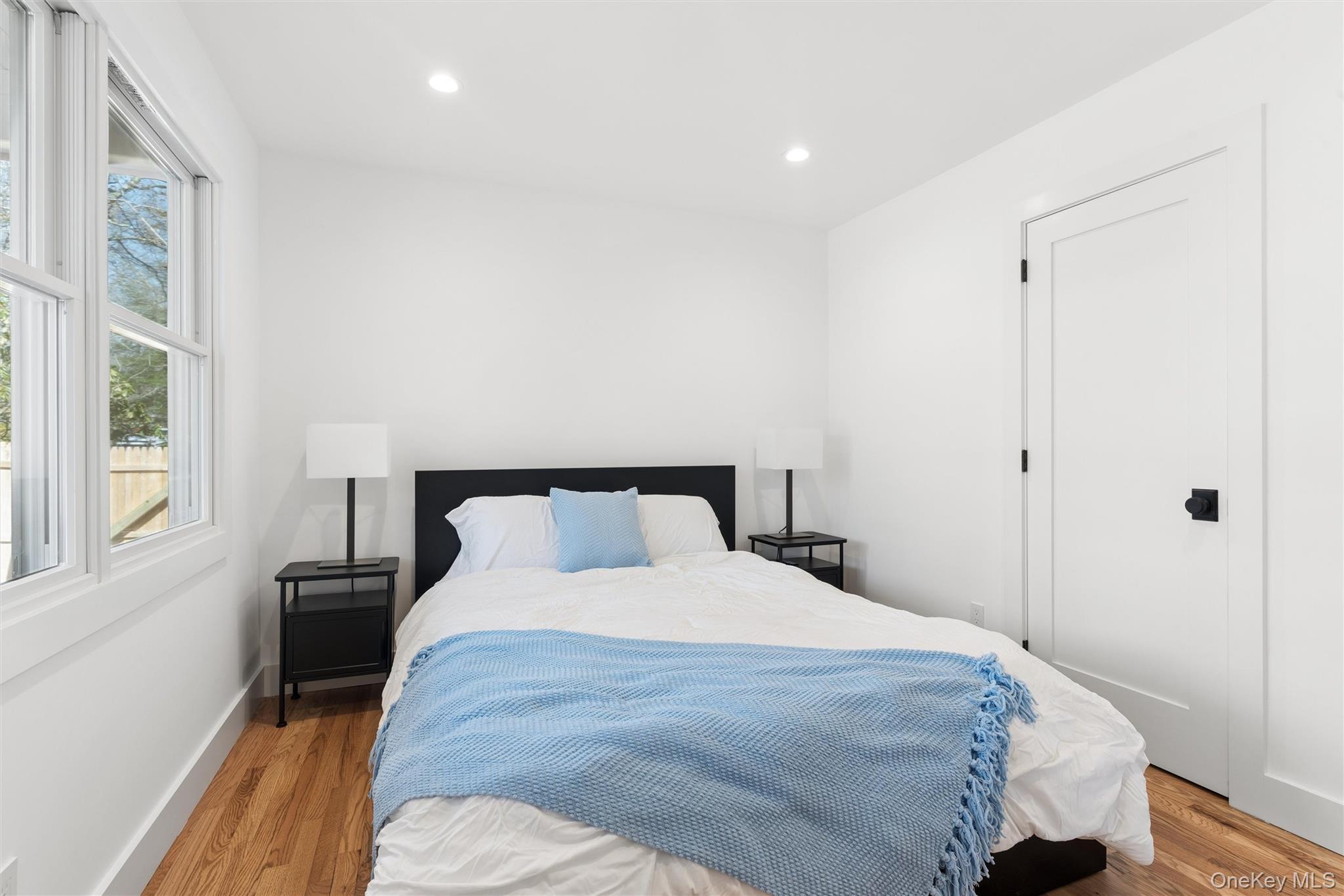 502 Springs Fireplace Road East Hampton, NY 11937 - Photo 10 of 25 a bedroom with a bed and wooden floor