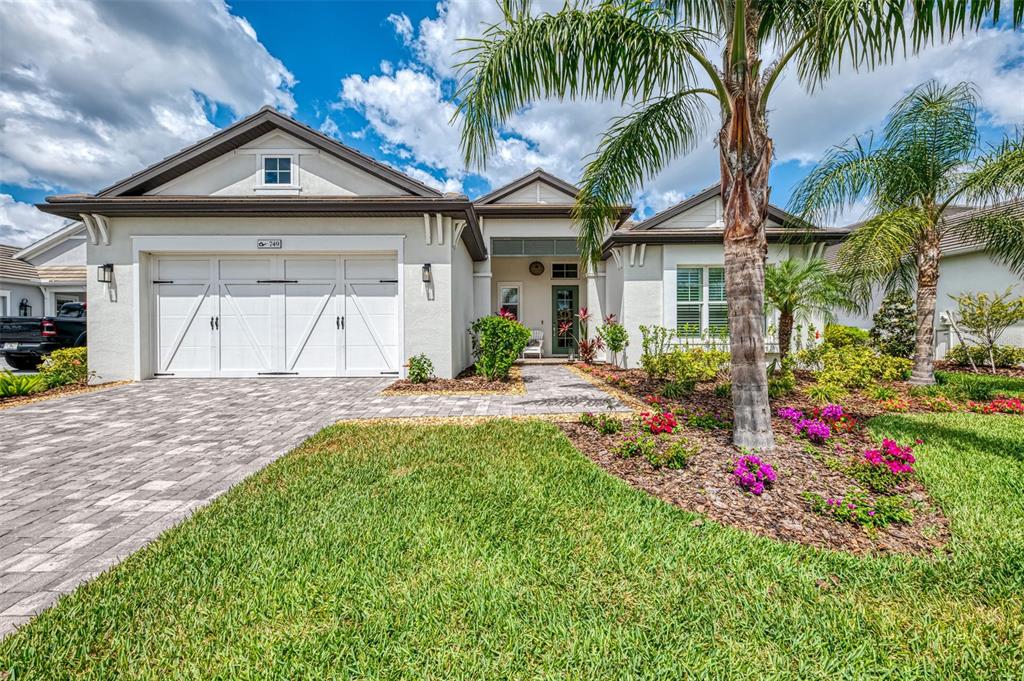 749 Tailwind Place Sarasota, FL 34240 - Photo 1 of 56 a front view of a house with a yard and garage