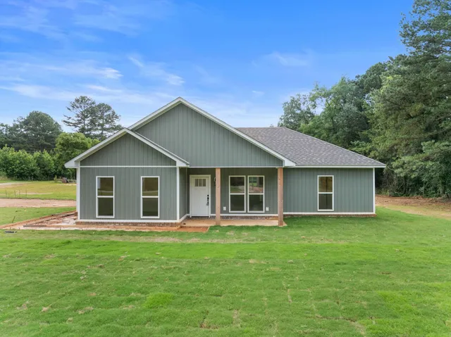 a front view of house with a garden