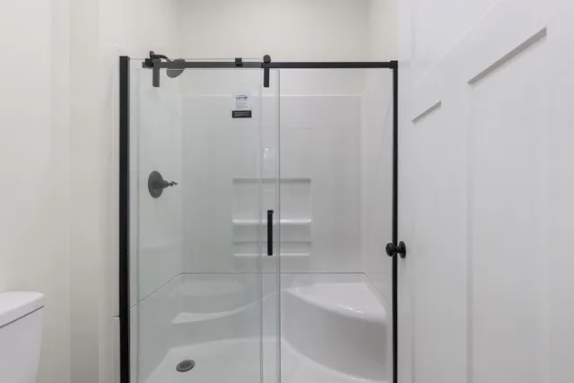 a bathroom with a shower and a bath tub