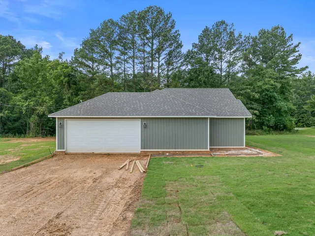 a front view of house with yard and trees
