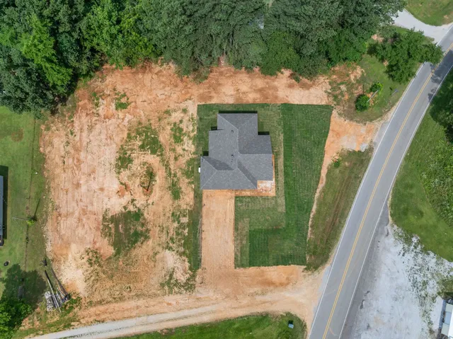 a view of a yard in front of a house with a fountain