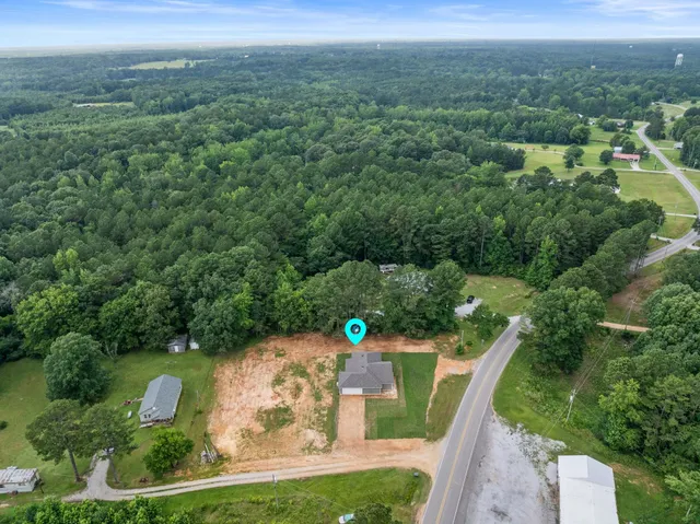 an aerial view of a house with a yard