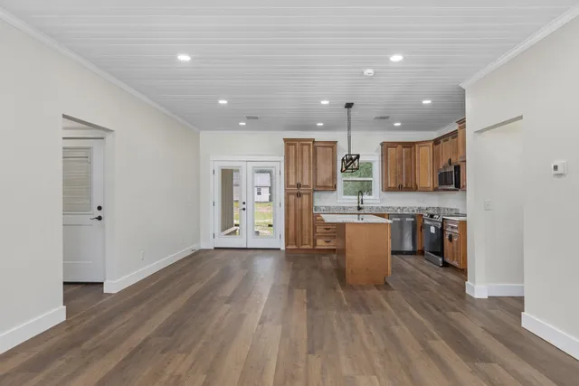 a kitchen with a refrigerator and a stove top oven