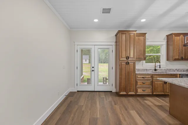 an empty room with windows and cabinet
